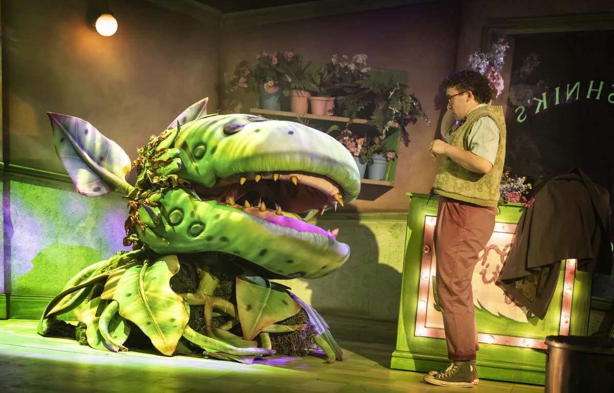 Left to right - Audrey II (puppeteered by Ross Lennon) with Kristian Cunningham. Pamela Raith Photography. 